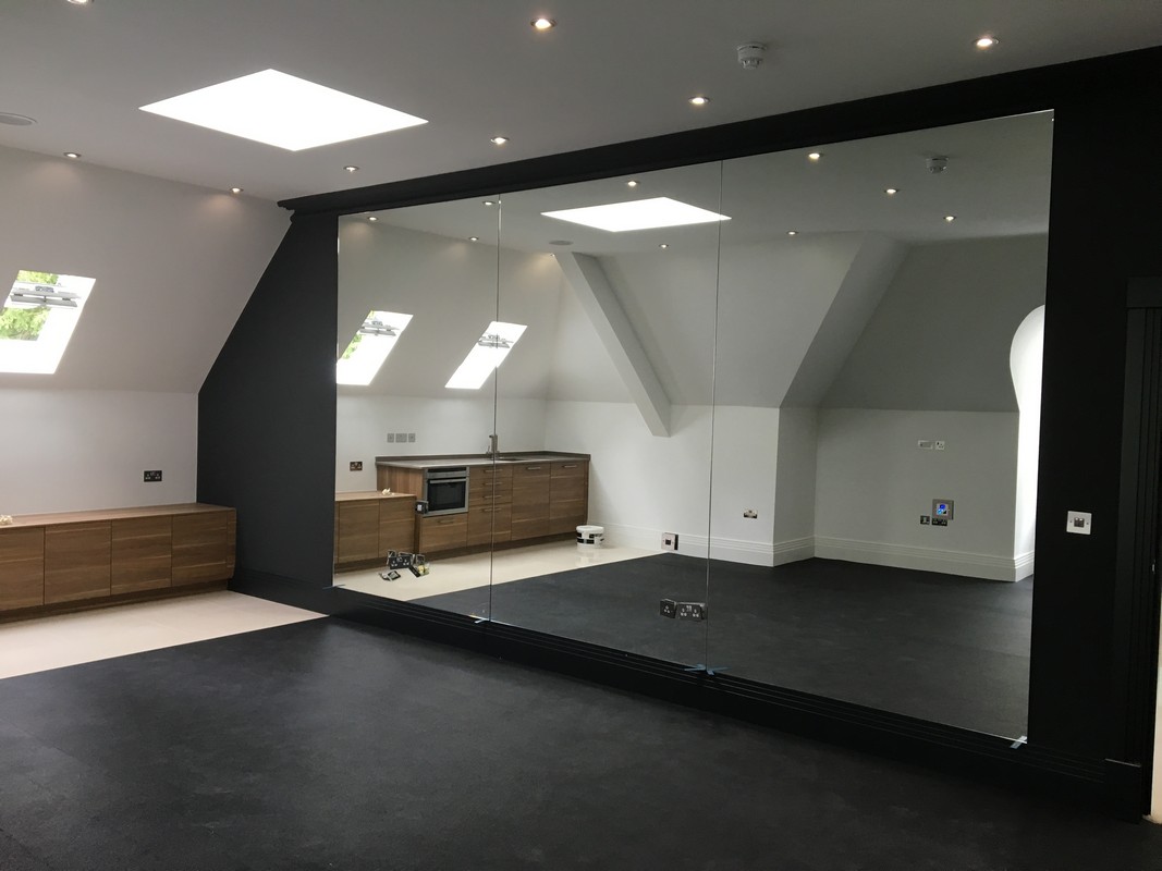 Frameless glass wall dividing loft conversion in Sydenham